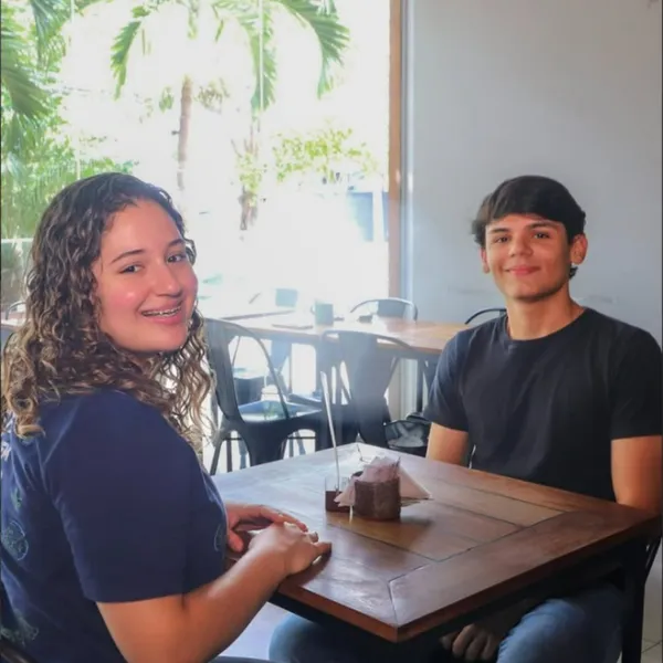 Dois clientes jovens sorrindo à mesa do Salatta